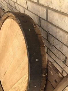 an old wooden barrel sitting next to a brick wall