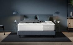 an image of a bedroom setting with mattress and night stand