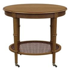 a round table with wicker on the bottom and two shelves underneath it, against a white background