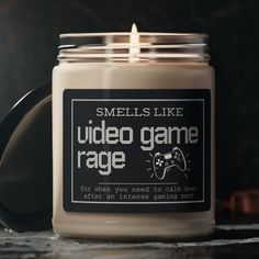 a candle that is sitting on a table with a video game logo in the jar