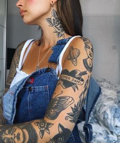 a woman with tattoos on her arm and chest