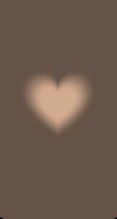 a heart shaped shadow on a brown background