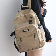 Introducing our Korean Front Pocket Backpack, the perfect companion for students who value style and functionality! This backpack combines a trendy Korean design with ample storage space, making it an ideal choice for school and beyond. Available in five beautiful colors - White, Black, Purple, Red, and Khaki - this backpack lets you express your personal style effortlessly. Whether you prefer a classic and clean look or a vibrant and eye-catching design, there's a color option to suit your tast Cheap Khaki Backpack, Cheap Streetwear Backpack With Zipper Pocket, Cheap Streetwear Backpack With Pockets, Affordable Khaki Backpack Shoulder Bag, Cheap Solid Color Backpack Chest Bag, Cheap Everyday Khaki Backpack, Cheap Khaki Backpack With Multiple Compartments, Casual Cheap Waterproof Backpack, Cheap Trendy School Chest Bag