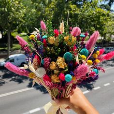 a person holding a bouquet of flowers on the street