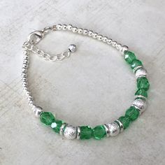 "THE DETAILS This bracelet features the August birthstone color of Peridot. The Peridot-colored glass beads have a faceted cut to reflect the light; the bracelet is also highlighted with silver shimmer stardust beads! These bracelets make wonderful gifts! ** PLEASE NOTE ** This item is not made of gemstone beads. The colored glass beads in the bracelet and earrings are meant to represent the birthstone color! ORDER OPTIONS When ordering, please use the \"Product Options\" menu to indicate if you Nickel-free Green Beaded Bracelets, Adjustable Lime Green Bracelets As Gift, Faceted Beads Bracelet For May Birthstone Gift, Faceted Beads Bracelets As May Birthstone Gift, May Birthstone Bracelets With Faceted Beads As Gift, Adjustable Green Sterling Silver Bracelet Gift, Green Bangle Charm Bracelet For Jewelry Making, Green Round Birthstone Bracelet, Adjustable Green Birthstone Jewelry