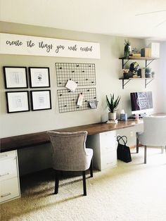 a desk with two chairs and pictures on the wall above it, along with other office furniture