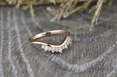 a close up of a gold ring with diamonds on it's side, sitting on a piece of fabric