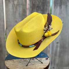 Hand shaped stiff brim yellow distressed wool cowboy hat.   Band is yellow embossed and smooth brown leather with turquoise ocean jasper and wooded beading detail.  Feather and dried flower details.  Branded sunshine on the back and under the brim.  One size fits most.  Adjustable band inside. Other fun colors and styles available! Clown Sona, Rodeo Clown, Cowboy Hat Band, Coachella Outfits, Turquoise Ocean, Coachella Outfit, Diy Hat, Yellow Shirts, Hand Shapes