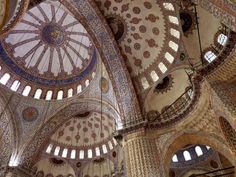 the interior of an ornate building with many windows