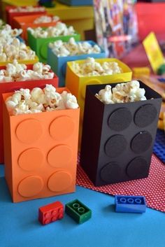 some legos are sitting on a table with popcorn