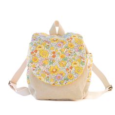 "Liberty of London Tana Lawn \"Betsy Yellow\" child's small-size back pack  Perfect for a birthday gift!  Made with 100% cotton canvas and the Liberty fabric used on the flap and side pockets.  Quilted lining to hold shape. The video is showing the blue version.  Recommended age is 1 year to 5 years old.  Magnetic clasp closure and scrunch opening for little hands.  Approx measurements are 7\"W / 10\"H / 4\"D (17.8 cm / 25.4cm / 10.2cm) Adjustable straps. Each back pack is handmade at time of order. If you do not see quantity you need in stock please message to see if we can accommodate your request. Custom orders are also welcome! Hand wash is recommended.  Fabric's pattern placement may vary slightly from what is pictured. Gift wrapping available upon request.  I usually ship in 1-3 busi Cute Cotton Backpack For Everyday Use, Cute Everyday Cotton Backpack, Cute Yellow Cotton Bags, Cute Cotton Backpack For Back To School, Cute Cotton Backpack For Daily Use, Cute Cotton Standard Backpack, London Kids, Floral Backpack, Liberty Of London