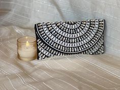 Thank you so much for visiting my shop ! **Handcrafted Black and Silver Crystal Embellished Clutch - Bold & Glamorous** Turn heads with this striking **handmade black clutch** featuring an intricate display of **silver crystals** in a mesmerizing circular pattern. The contrast between the deep black fabric and the dazzling crystal embellishments creates a bold, high-fashion statement. Perfect for special occasions, evening events, or when you want to add an extra dose of glamour to your outfit. Handmade Silver Clutch For Party, Elegant Party Clutch With Mirror Work, Traditional Silver Clutch For Party, Silver Traditional Party Clutch, Traditional Silver Party Clutch, Silver Festive Party Clutch, Festive Silver Party Clutch, Elegant Silver Clutch For Festive Occasions, Traditional Silver Embellished Clutch