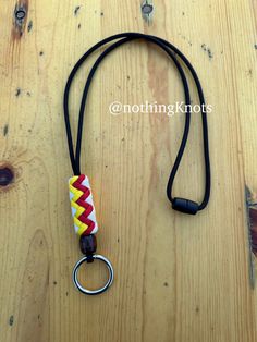 This is a paracord neck lanyard/badge holder made with 550 paracord in KC Chiefs colors - Red, Gold, and White on a breakaway clasp. There is a wooden bead at the base of the knot and a silver O ring at the bottom. The entire lanyard is 18 inches long. Paracord Neck Lanyard, Duck Call Lanyard, Paracord Accessories, Lanyard Badge Holder, Custom Lanyards, Neck Lanyard, Badge Lanyard, Kc Chiefs, Wichita Ks