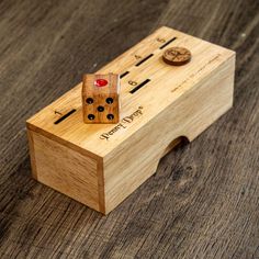 a wooden box with two dices in it