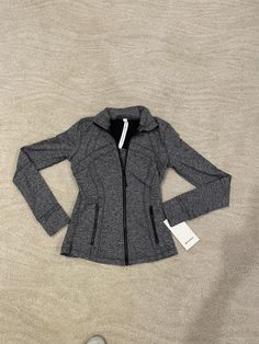 Item: Lululemon Women's Heathered black (gray) Define jacket *Luon, zipper pockets, high neck collar, light weight, sweat-bickering fabric, secure front pockets, four-way stretch, smooth feel, thumbholes, & muffins, slim fit, hip length, Size 6. Brand new with tags, retail $118 Buy it now or send me an offer  Postage, tracking & packaging $8.95 No returns, sold as seen, if you have any questions please ask. Payments: please pay as soon as the item ends. I will dispatch items within 1-3 working days Thanks for looking 😉 Check out my other items for said Fitted Lululemon Sports Outerwear, Lululemon Fitted Sports Outerwear, Lululemon Sports Outerwear With Pockets, Lululemon Winter Outerwear With Zipper Closure, Winter Outerwear With Zipper Closure By Lululemon, Stretch Lululemon Outerwear, Lululemon Stretch Long Sleeve Outerwear, Lululemon Long Sleeve Stretch Outerwear, Lululemon Stretch Winter Outerwear