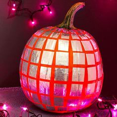 a lighted pumpkin sitting on top of a table