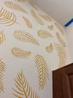 a wall with gold leaves painted on it