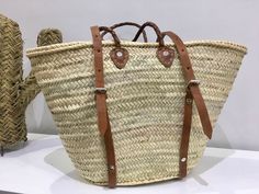 a woven basket sitting on top of a white table