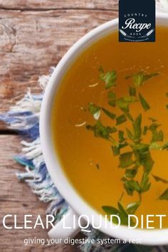 a white bowl filled with soup and garnished with green leafy herbs on a wooden table