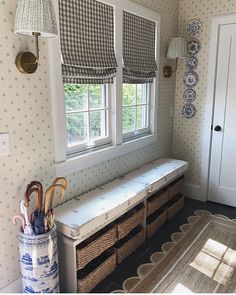 a room with two windows and some baskets on the floor