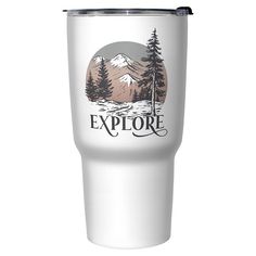 a white tumbler cup with the words explore on it and mountains in the background