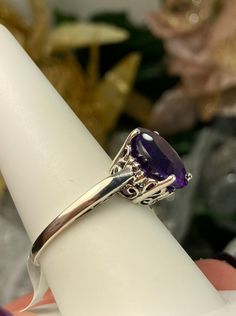 Natural Purple Amethyst Solid Sterling Silver RingK Design#D4 This is a brand-new Victorian design in solid sterling silver. The beautiful trellis filigree of the 5-carat ring is crafted in an amazing vintage style. This full cut sparkling gemstone is 13mm (approximately 1/2") in diameter. The inside of the band is marked 925 for sterling silver. It is a ring that will be treasured as an heirloom. Notice the beautifully intricate design of the silver filigree setting and trellis band. This allur Fine Jewelry Amethyst Ring With Intricate Design, Elegant Purple Amethyst Ring With Intricate Design, Purple Promise Ring With Intricate Design, Purple Intricate Design Promise Ring, Fine Jewelry Amethyst Ring With Intricate Design For Anniversary, Exquisite Hallmarked Amethyst Ring, Purple Oval Filigree Rings, Classic Sterling Silver Amethyst Ring With Prong Setting, Exquisite Hallmarked Sterling Silver Rings