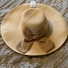 Large Hat With Bow. Never Worn. Brown One-size Sun Hat For Spring, Brown One Size Sun Hat For Spring, Brown Bucket Hat For Spring, Beige Straw Hat For Spring, Adjustable Neutral Hat For The Beach, Neutral Wide Brim Hat For Spring, Spring Beach Hat In Neutral Color, Neutral Beach Hat For Spring, Spring Neutral Wide Brim Hat