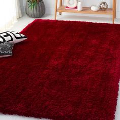 a red area rug in a white room