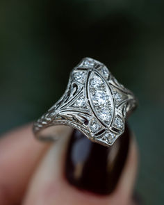 A close-up image showing an antique platinum art deco shield engagement ring with old european cut diamonds and filigree Antique Art Deco Engagement Rings, 1920s Jewelry, Art Deco Jewelry Vintage, 14k Gold Wedding Ring, Vintage Art Deco Rings, Shield Ring, Antique Diamond Rings, Platinum Diamond Rings, Antique Engagement Rings