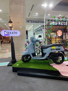 a scooter on display in front of a store