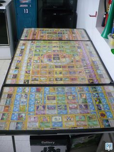 the table is covered with many different colored tiles and papers on it's sides