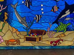 a stained glass window with sea animals and marine life