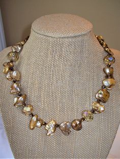 This gorgeous gold Biwa Pearl and faceted crystal choker necklace is a joy to wear. It is made with various sized & shaped one-sided gold Biwa Pearls, large faceted golden crystal  beads, and small faceted bronze-tone quartz rondelle spacers.  It is a 15 1/2 inch choker adjustable to 18 inches with a 14K gold filled chain extender.   Lovely to wear with any color outfits to add drama and a classic look. You can wear it with our matching bracelet. Unlike vermeil or gold plated, 14K gold filled wi Golden Crystal, Color Outfits, Biwa Pearls, Crystal Choker Necklace, Pearl Choker Necklace, Crystal Choker, Chain Extenders, Matching Bracelet, Pearl Choker