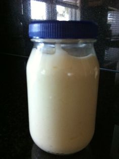 a glass jar filled with milk sitting on top of a counter