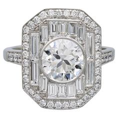 This Art Deco platinum ring has a center stone that weighs a total of 1.50 carat. Surrounded and accentuated with baguette cut and round diamonds that is approximately 1.13 carats. Sophia D by Joseph Dardashti LTD has been known worldwide for 35 years and are inspired by classic Art Deco design that merges with modern manufacturing techniques. Ring Art Deco, Platinum Ring, Baguette Cut, Art Deco Design, Diamond Art, Cocktail Rings, Classic Art, Round Diamonds, Platinum