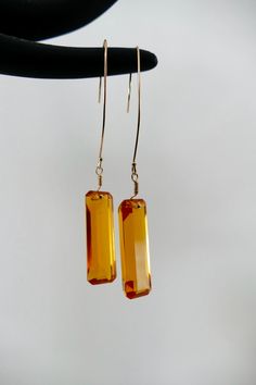 "These beautiful orange/gold 30x10mm citrine baguettes will complement any outfit.  The earrings are a total of 3\" long and finished using 14k gf extra long shepherd hook ear wires. ~~Citrine's metaphysical qualities are that it helps boost physical energy and assists with digestion and blood circulation~~" Baguette Earring, Shepherds Hook, Orange Gold, Ear Wires, Citrine, Jewelry Earrings Dangle, Etsy Earrings, Dangle Drop Earrings, Dangle Earrings