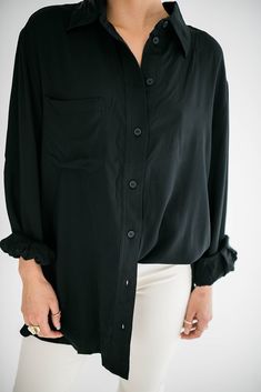 A timeless wardrobe essential that seamlessly combines style and comfort. Our Marino button up is designed with a modern, relaxed fit that drapes perfectly, providing a flattering silhouette for all body types. Size Chart Features: oversized fit collared neckline buttons front pocket buttoned cuffs fabric content: 100% rayon model is wearing a small. Height 5'7" Bust 34", Waist 25", Hip 36" Chic Shirt With Roll-up Sleeves For Everyday, Versatile Fall Blouse With Roll-up Sleeves, Chic Everyday Shirt With Collared Neckline, Versatile Oversized Shirt For Work, Versatile Workwear Shirt With Shirttail Hem, Classic Daywear Blouse With Buttoned Pockets, Classic Oversized Tops With Button Closure, Chic Shirt With Lapel Collar In Relaxed Fit, Oversized Modern Tops With Button Closure