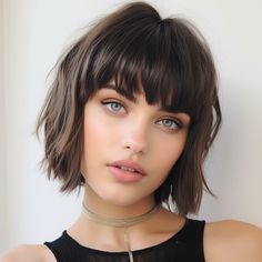 This modish shag cut, complete with textured bangs, exudes a rock ‘n’ roll edge. The layered cut provides volume and movement, while the bangs offer a casual, face-framing effect. This hairstyle is perfect for those with a bold personality who wish to showcase their flair for the dramatic, without sacrificing ease and comfort. Grow Out Bangs, Textured Bob With Bangs, Short Shag With Bangs, Bangs 2024, Baby Bangs Long Hair, Shag Bob, Hair Bobs, Short Hair Fringe, Haircuts Trendy