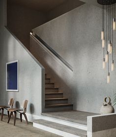 the stairs are made of concrete and have lights hanging from them