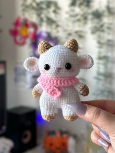 a small crocheted stuffed animal with a scarf around it's neck