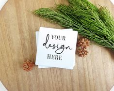 a piece of paper with the words your design here on it next to some pine cones