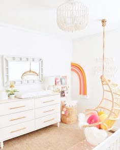 a baby's room with a hammock hanging from the ceiling