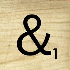 a close up of a wooden sign with an amp and i symbol on the front