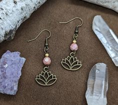 ◄ sacred earrings ► Lotus flower charm earrings featuring various beads. Boho chic style. Earrings measure approximately 1.75 inches long. (Listing is for one pair) Spiritual Beaded Earrings With Ear Wire For Gift, Flower Charm Earrings With Round Beads As A Gift, Spiritual Beaded Drop Earrings, Handmade Pink Spiritual Earrings, Flower Charm Round Bead Earrings For Gifts, Bohemian Beaded Earrings With Flower Charm, Handmade Spiritual Pink Earrings, Spiritual Beaded Drop Earrings For Gift, Bohemian Hypoallergenic Adjustable Flower Earrings