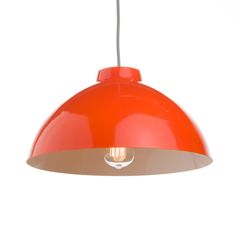 an orange pendant light hanging from a ceiling