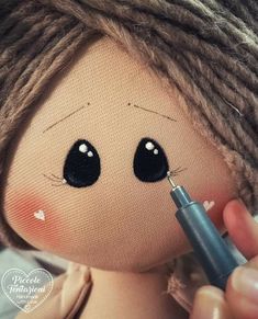 a doll with dreadlocks is holding a needle