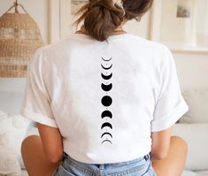 "Moon Phases Shirt, Moon Shirt, Moon Phases Tshirt, Moon Tee, Moon Phases Tee,Celestial Shirt, Space Lover Shirt, Boho Shirt,Back Printed The Design will be printed to the back of the shirt in white color on dark colors and in black color on the light colors. Please don't hesitate to contact me if you need anything special! HI there! I'm Daisy, the owner of DaisyTeeUS. I'm so glad to see you here. My priority is to make you happy with your purchase. Please contact me if you have any questions or Moon Phase Shirt, Boho Tshirt Design, Moon Phases Shirt, Moon Tshirt, Celestial Shirt, Boho Tshirts, Trendy Shirt Designs, Merch Ideas, Moon Shirt