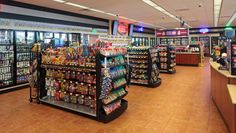 the inside of a grocery store filled with lots of food and drink bottles on display