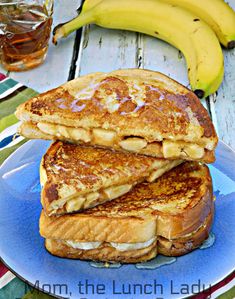 two pieces of french toast stacked on top of each other with bananas in the background