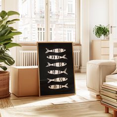 a black and white sign sitting on top of a wooden floor next to a potted plant